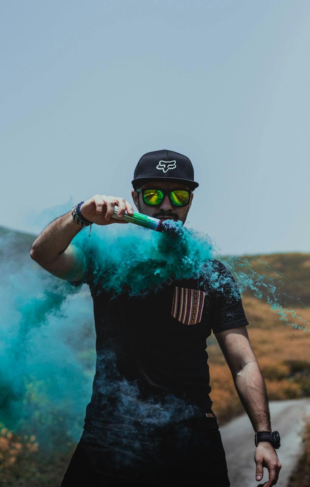 man holding teal powder