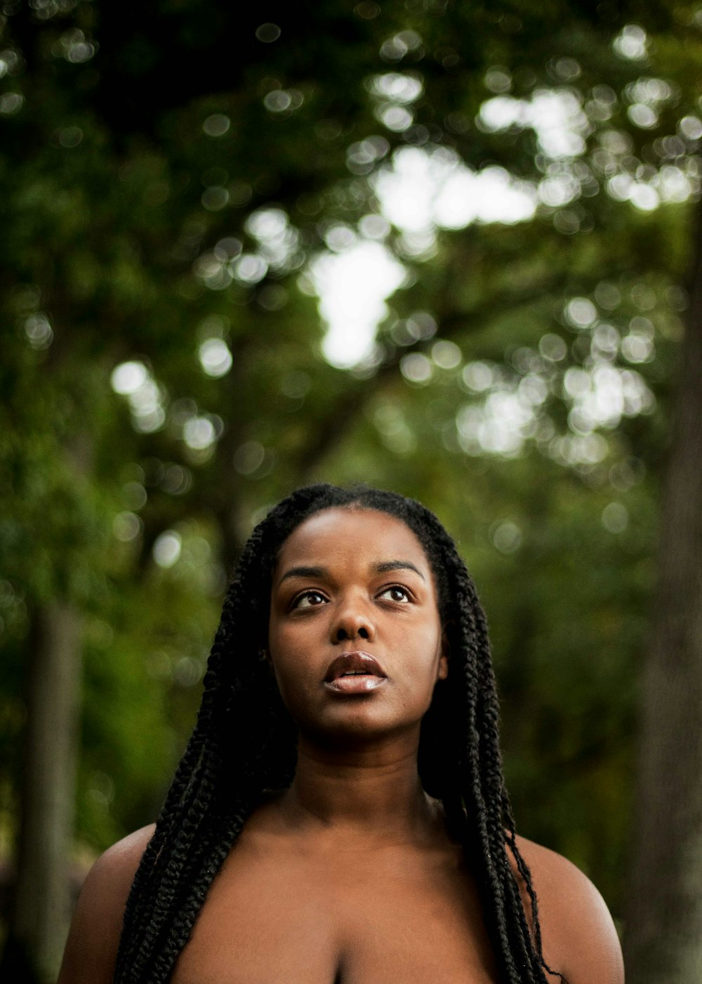 woman standing under tree