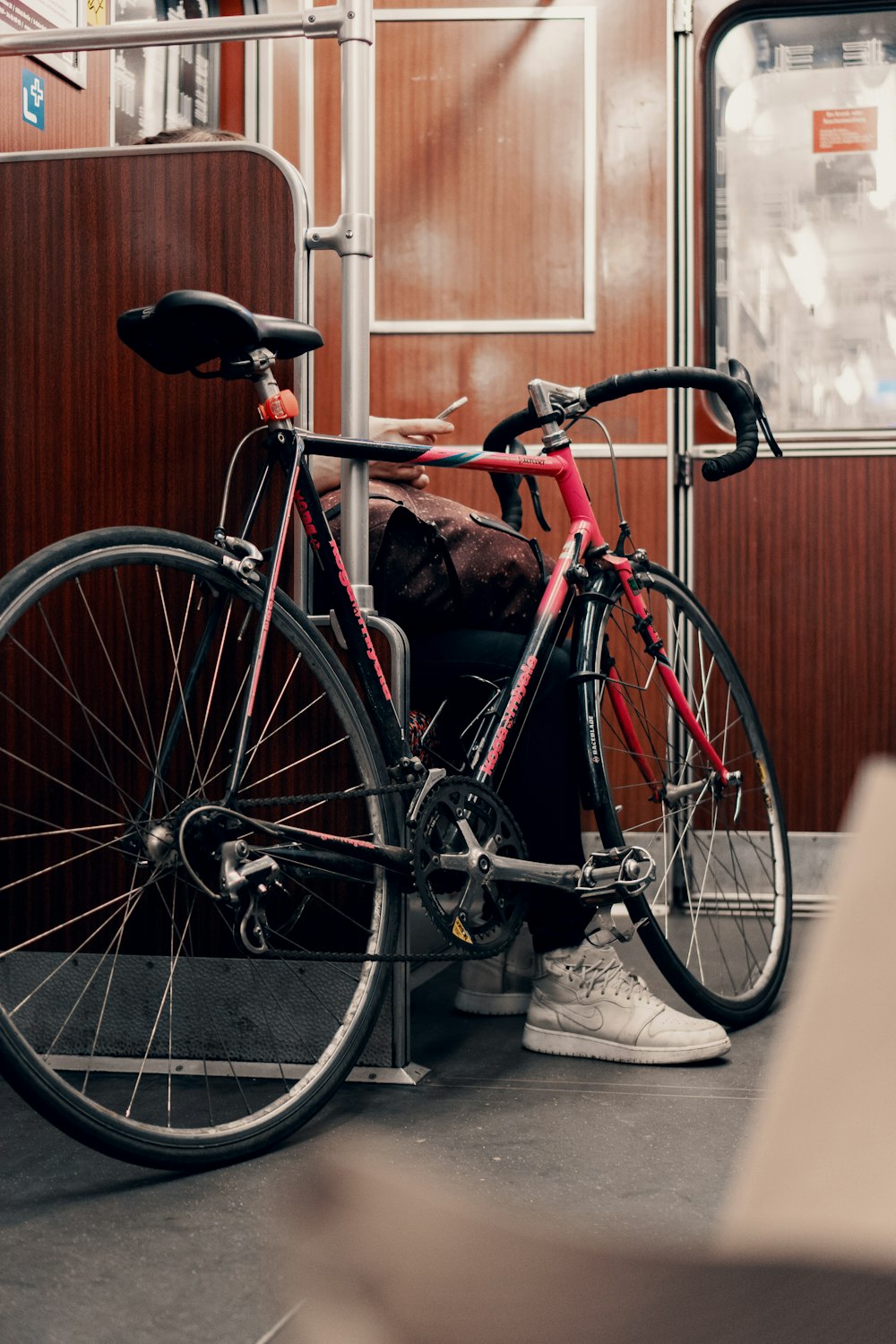 black and red road bike in train