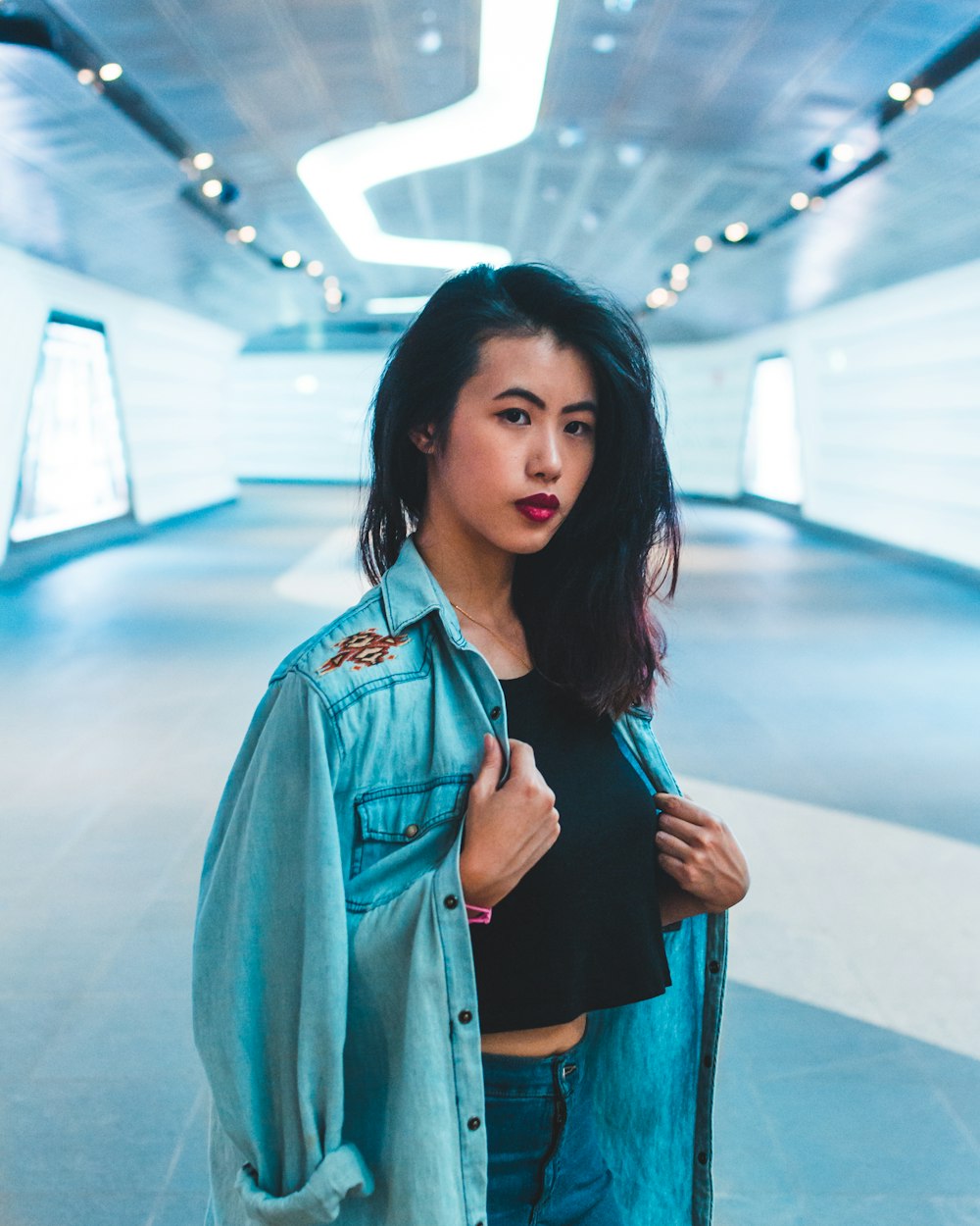 shallow focus photo woman in blue denim jacket