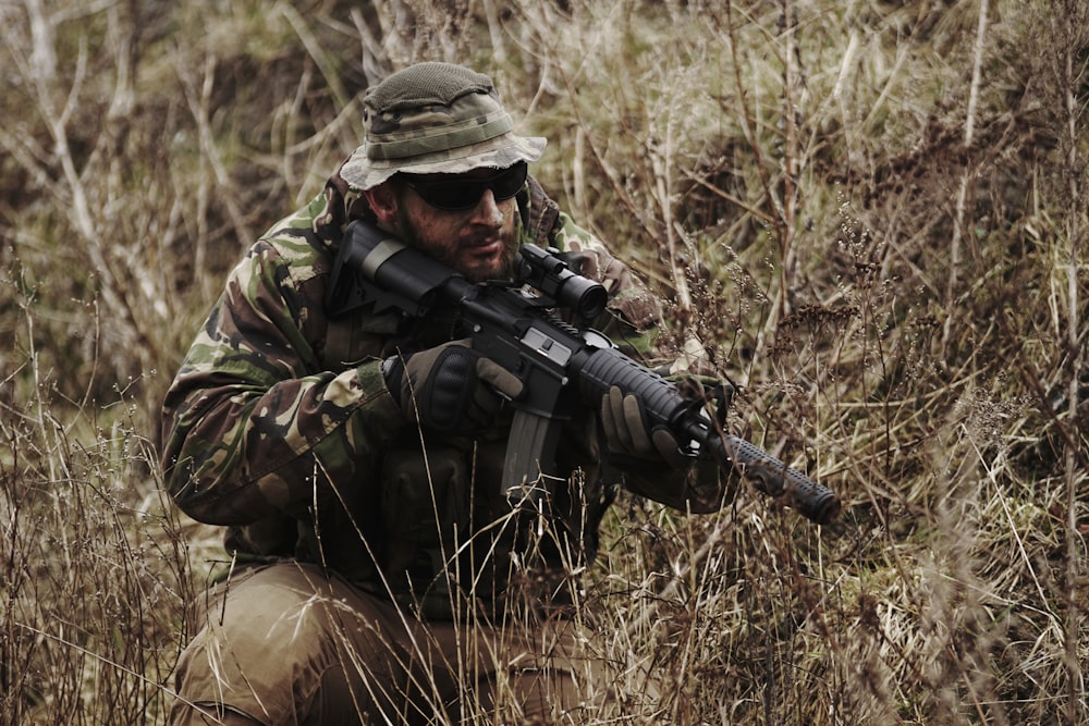 soldier holding black assault rifle