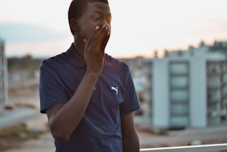 A friendly technician in navy blue uniform inspecting a backyard on Long Island at sunset