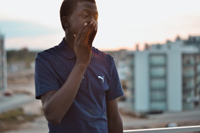 A friendly technician in navy blue uniform inspecting a backyard on Long Island at sunset