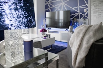 A modern living room with a stylish flat-screen TV mounted flawlessly on a dark accent wall.