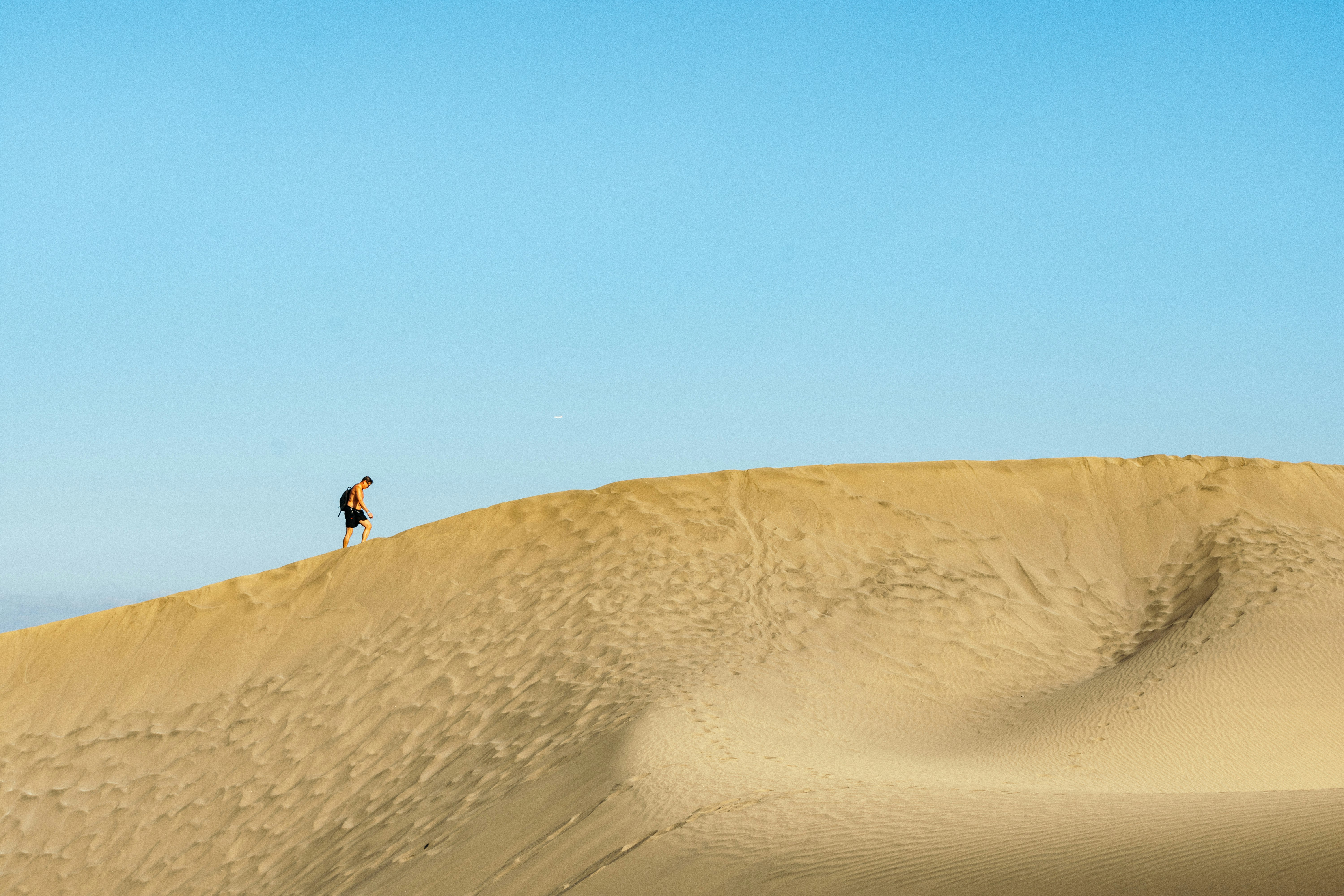 person walking on desert