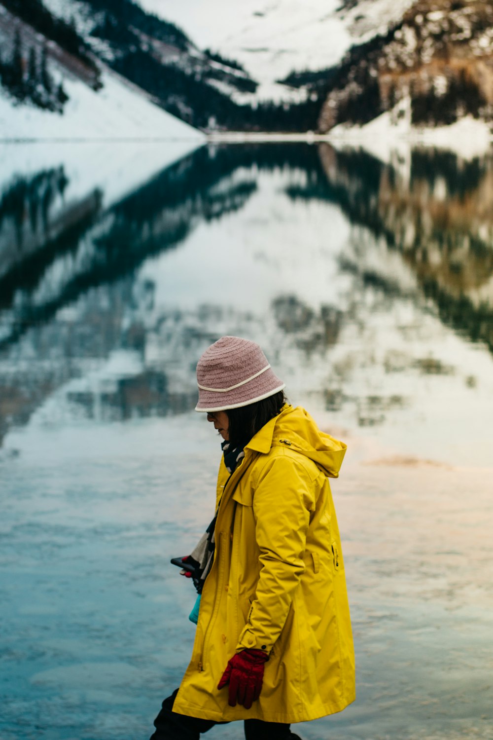 woman wearing yellow jacket with brown knit cap