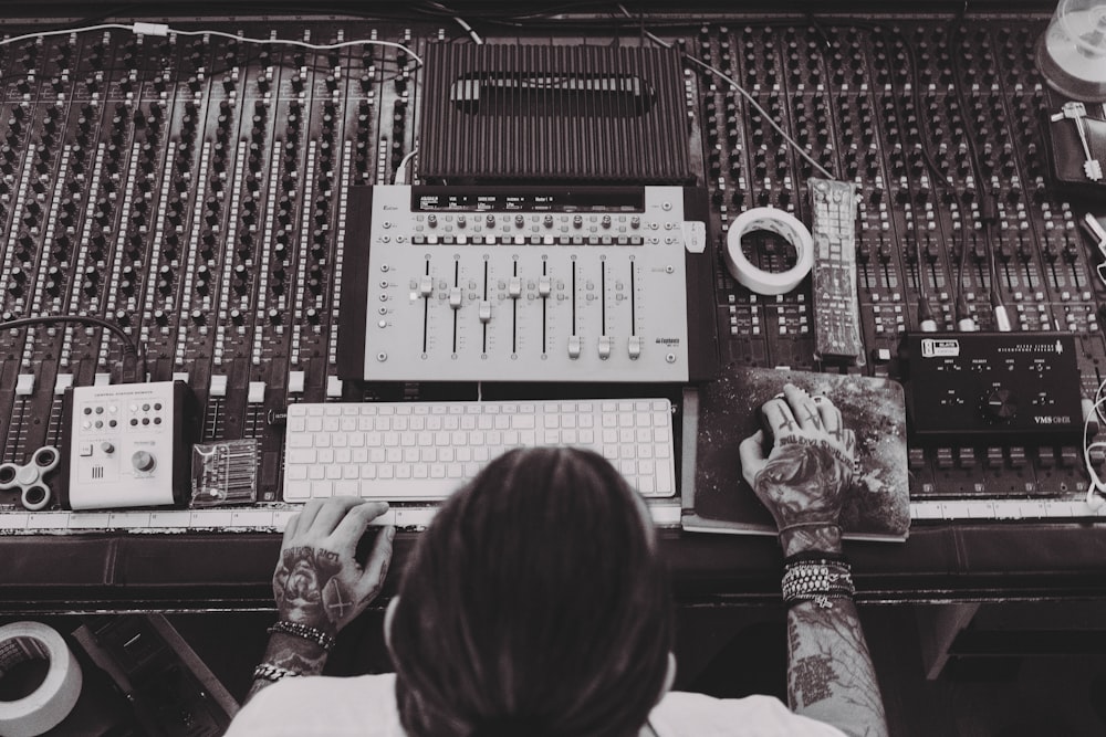 person controlling the audio mixer panel