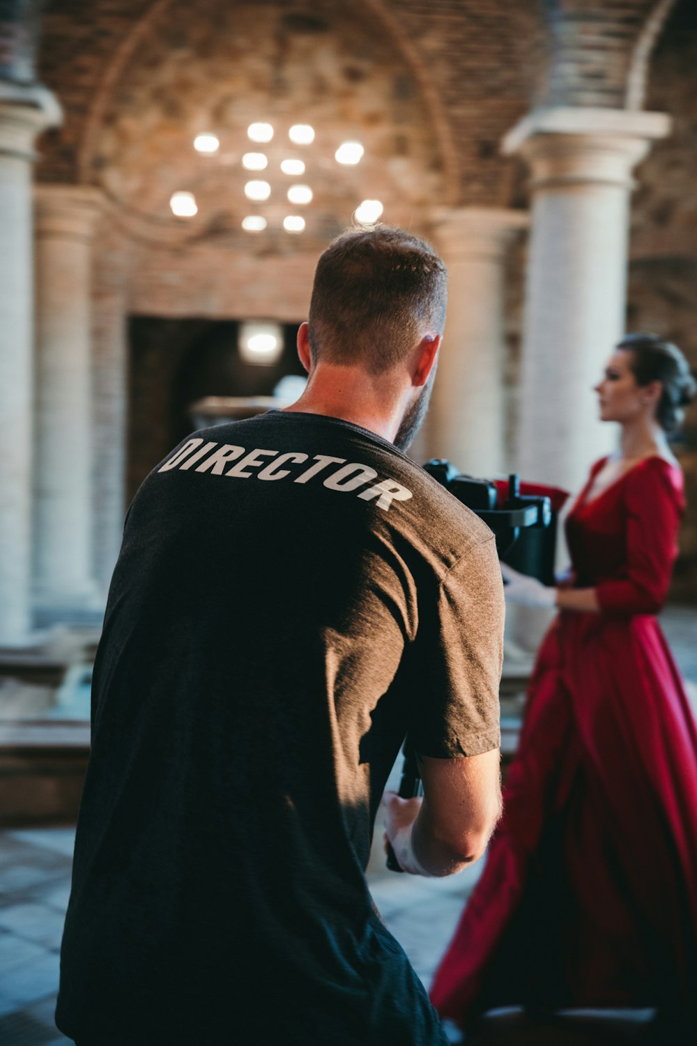 man wearing black Director t-shirt