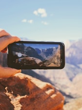 A scenic view of a famous US landmark with a traveler capturing the moment on camera.