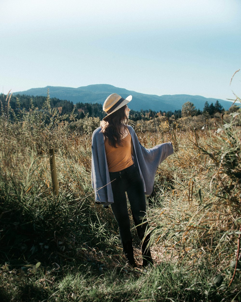 woman walking in grass fields