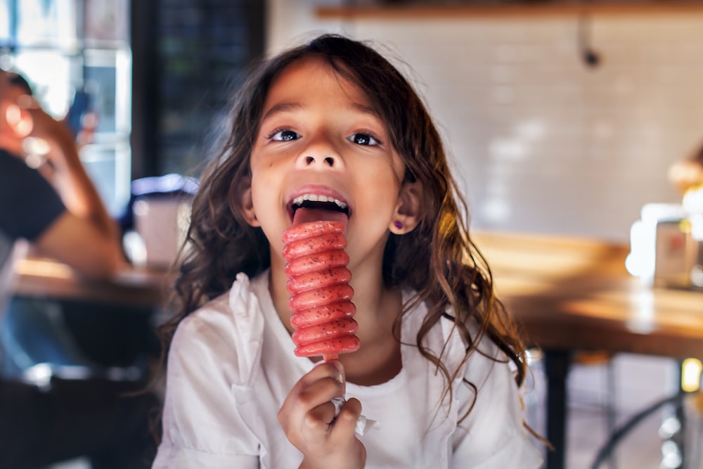 girl licking popsicle