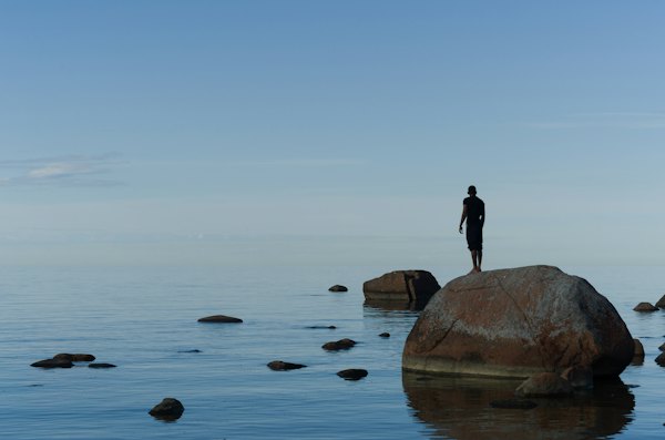 Man standing on brown rock — Lahemaa, Estonia