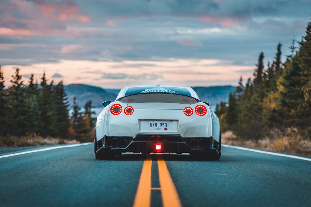 white sports coupe on road