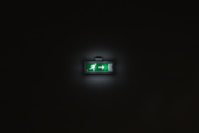 Close-up of vibrant lime green graphics illustrating safety tips on a black screen.