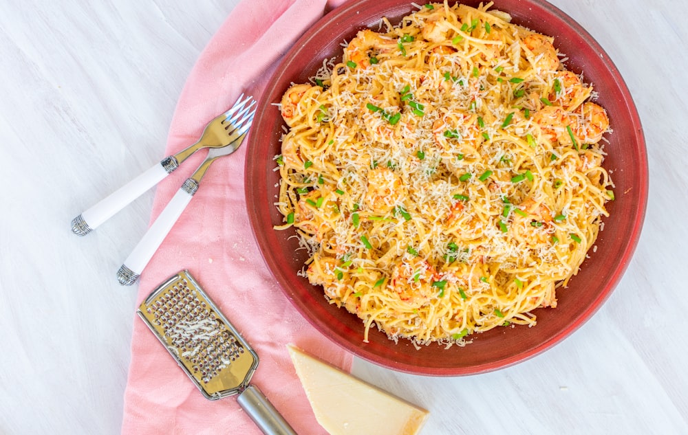 pasta on red plate with fork