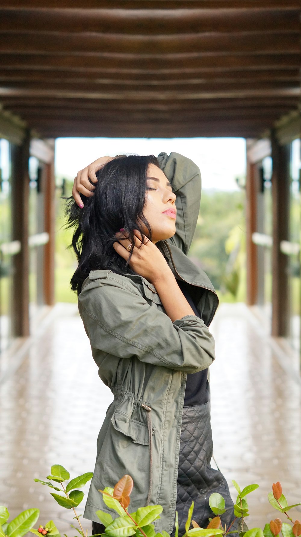 woman standing while wearing gray jacket during daytime