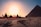 five persons riding camels walking on sand beside Pyramid of Egypt