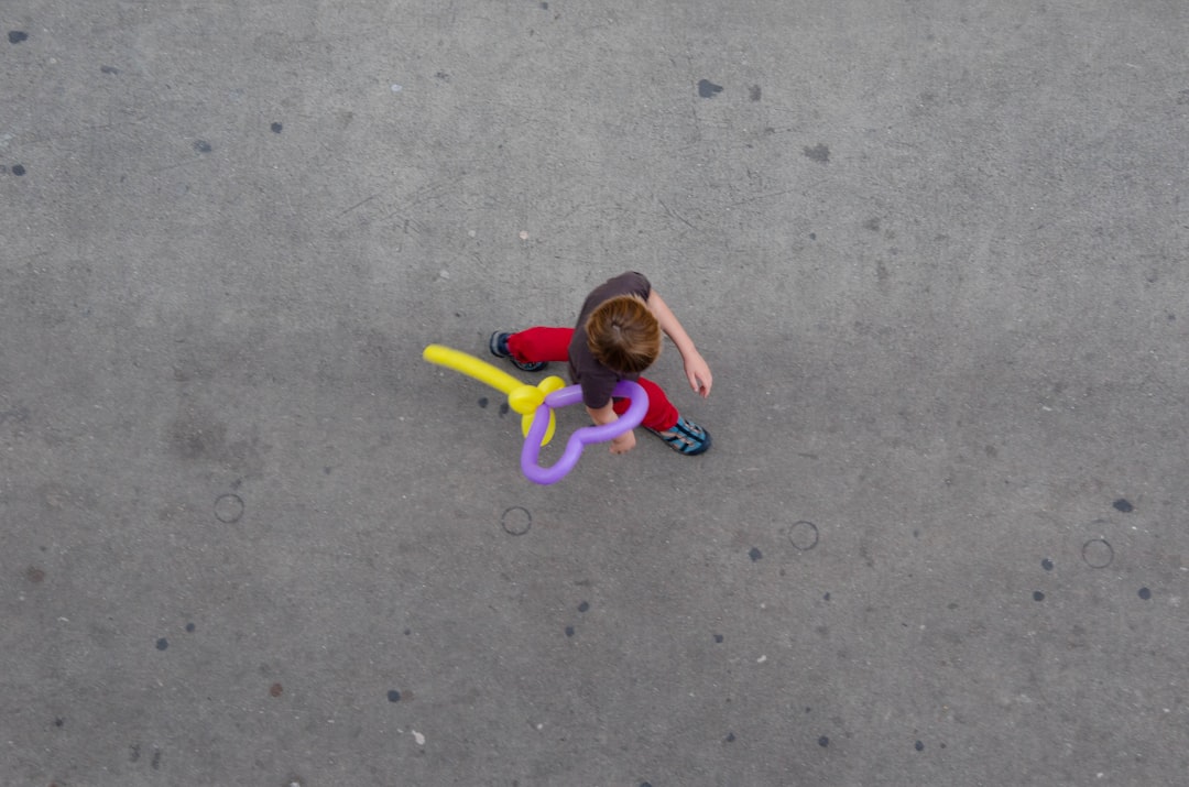 aerial view of person walking while holding balloon