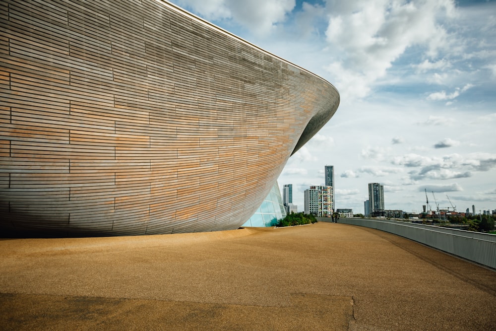 a large building with a curved wooden facade