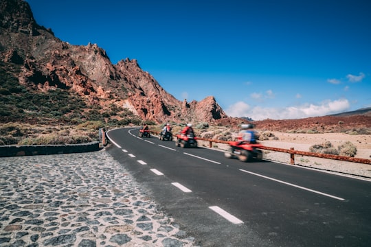 four persons riding ATV on road in Teide National Park Spain