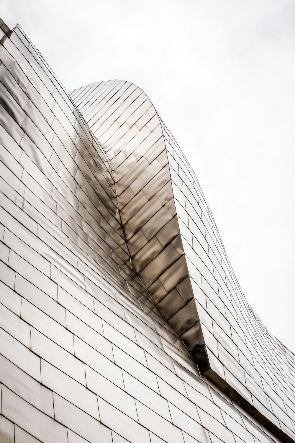 curved-top glass building under white sky