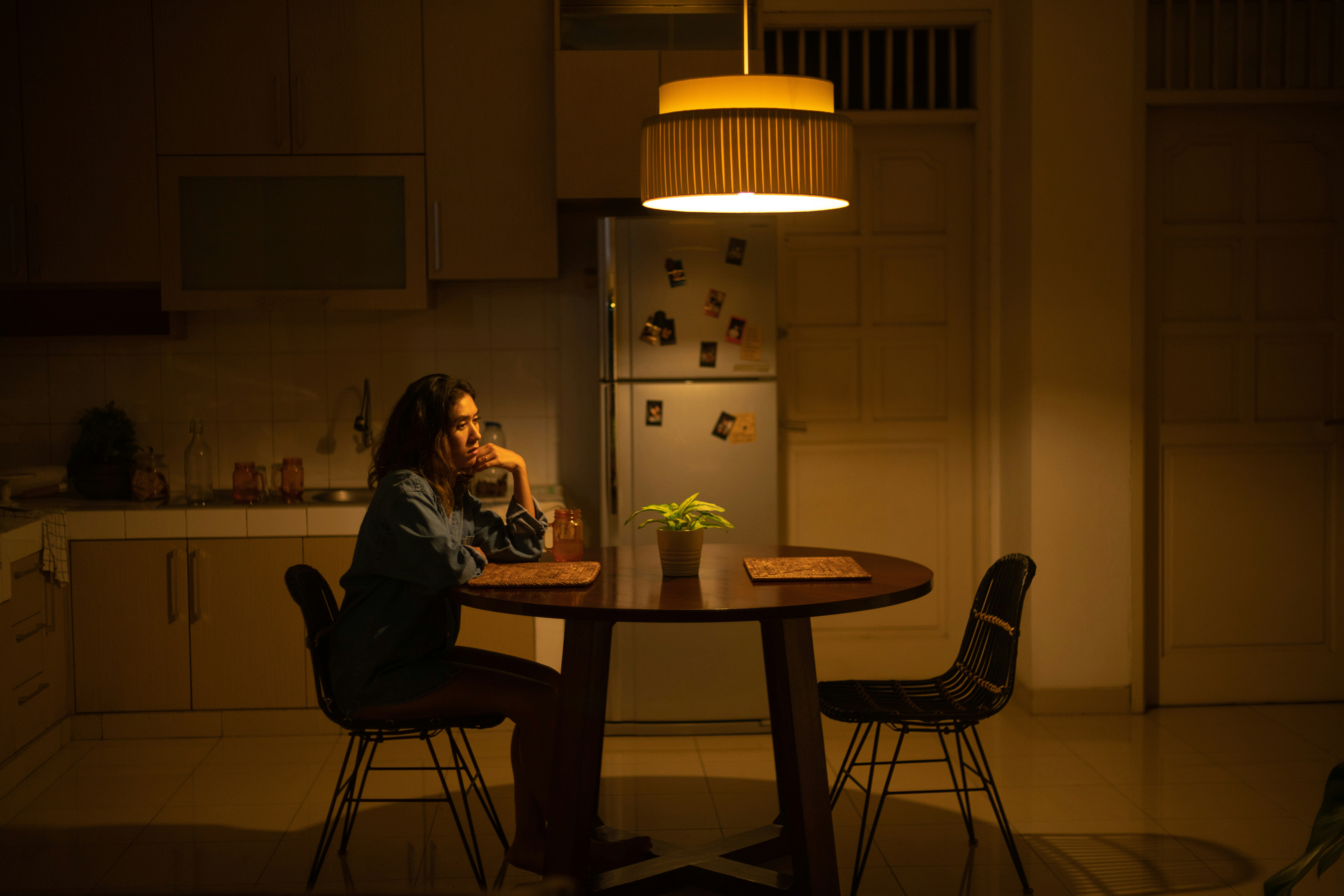 woman sitting on chair infront of table