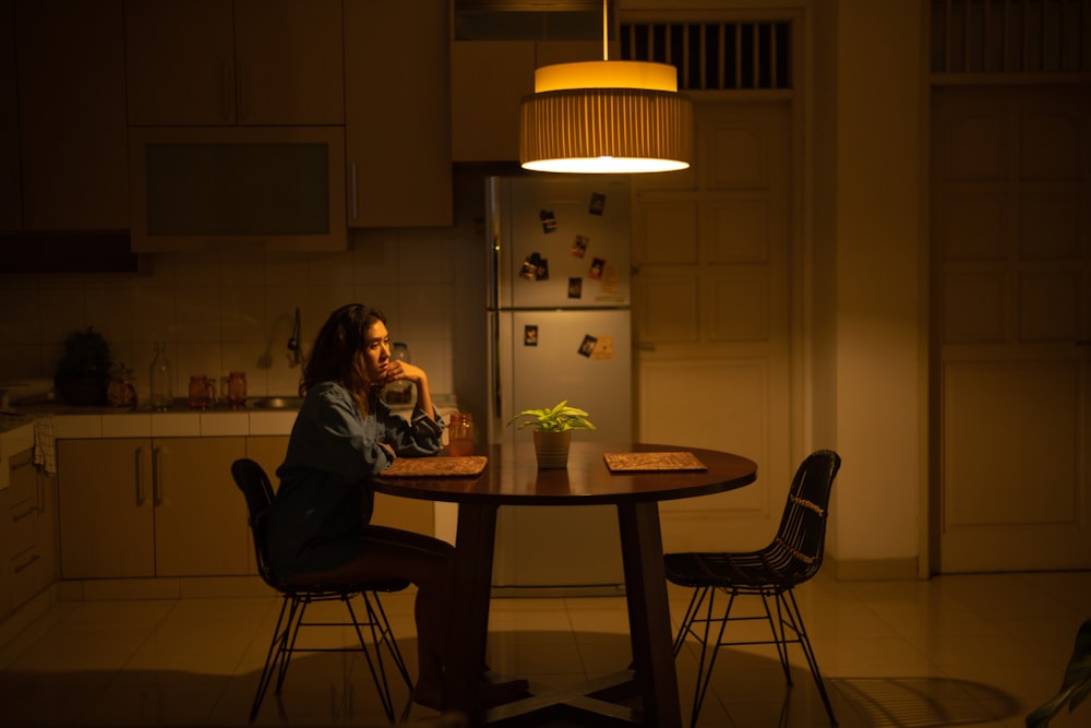 woman sitting on chair infront of table