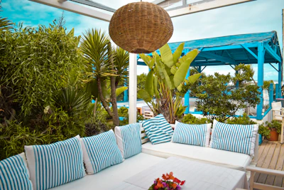 An elegant outdoor living space with sophisticated seating and subtle brass accents.