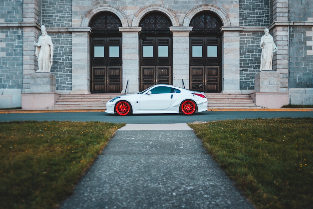 white car parked outside building