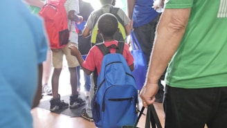 Children and parents happily walking through colorful school hallways during a guided tour.