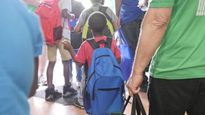 Parents and children touring the school campus together.