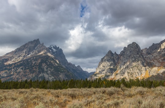 grey mountain under grey cloudy clouds in Grand Teton National Park, Jenny Lake United States