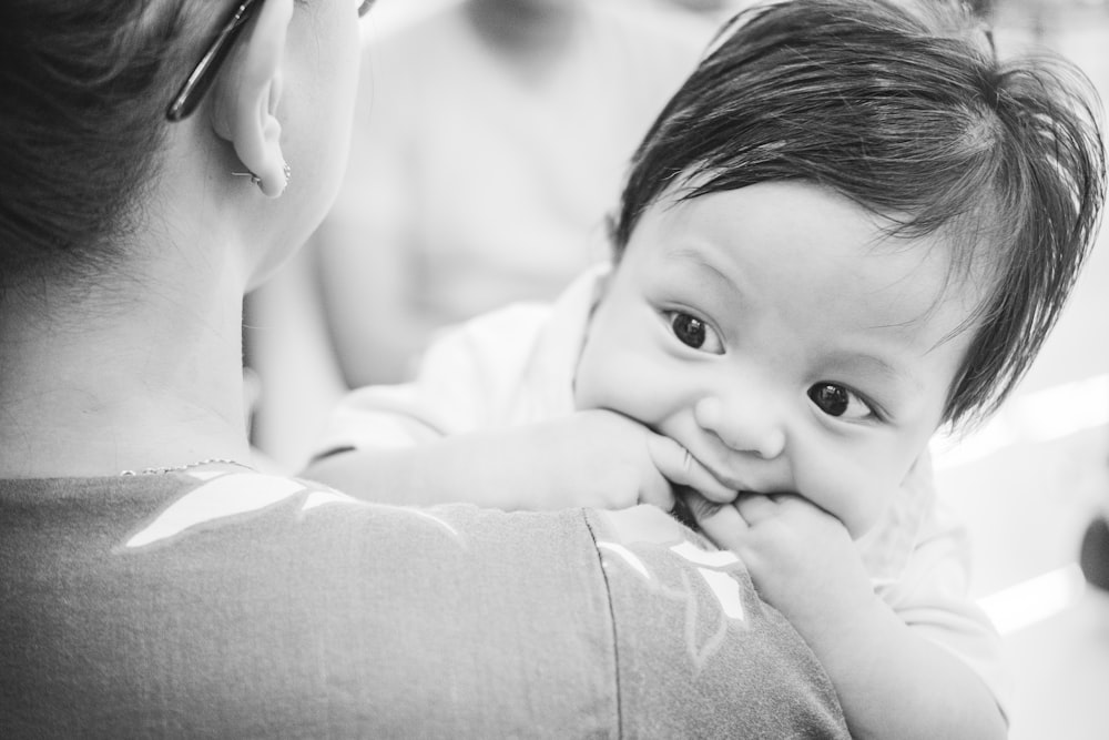 a woman holding a baby in her arms