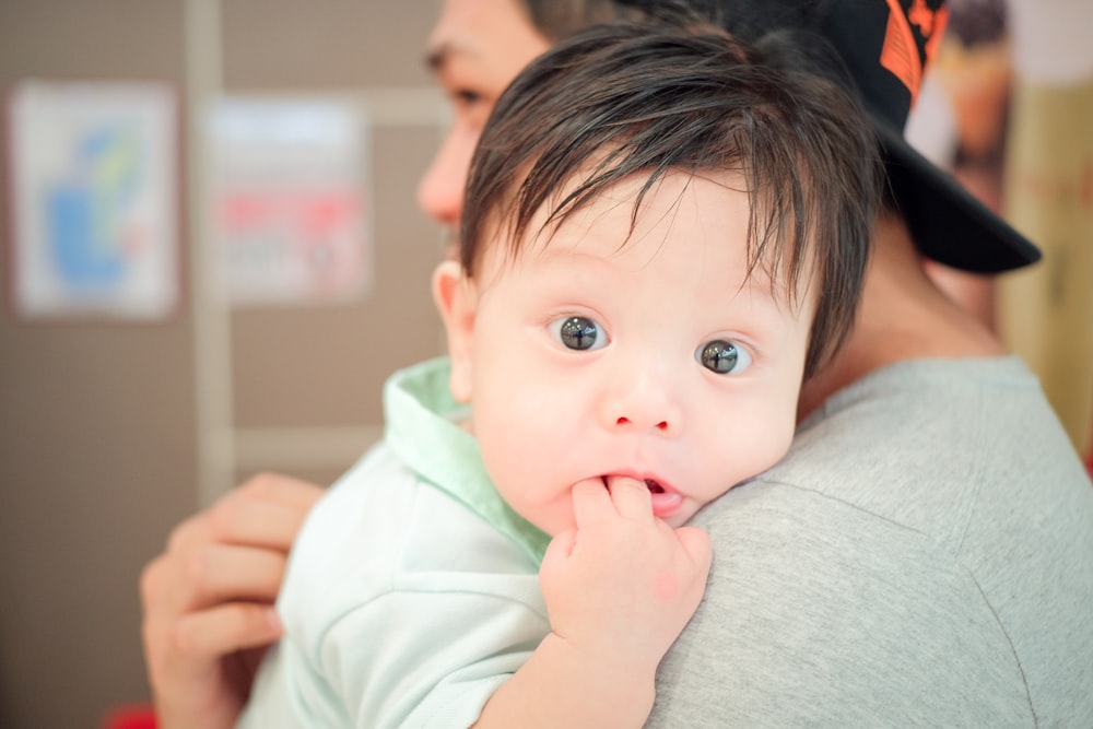 a man holding a baby in his arms