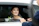 Smiling bride stepping out of a sleek black limousine in Chicago.