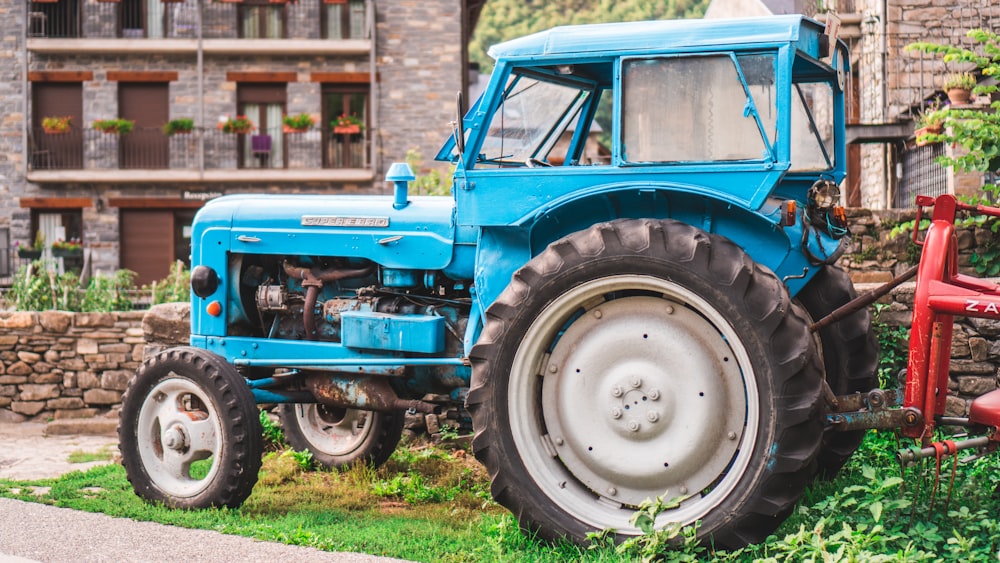 blue tractor parked outside house