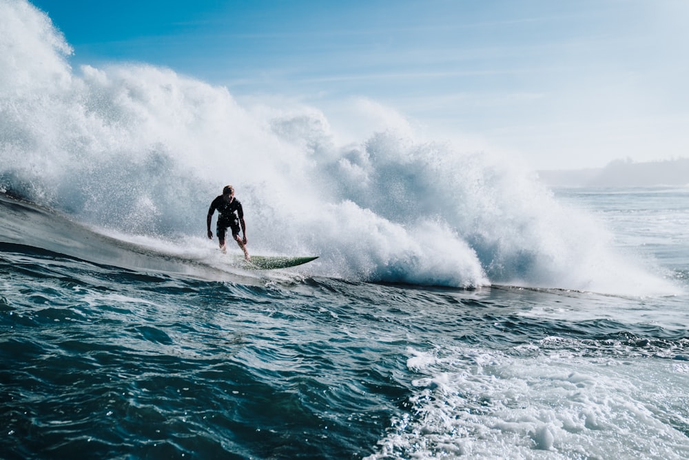 man doing surfing during daytime