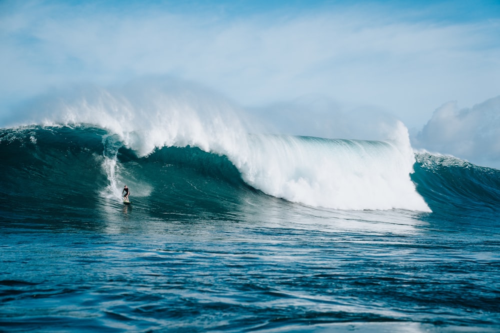 person surfing towards sea waves