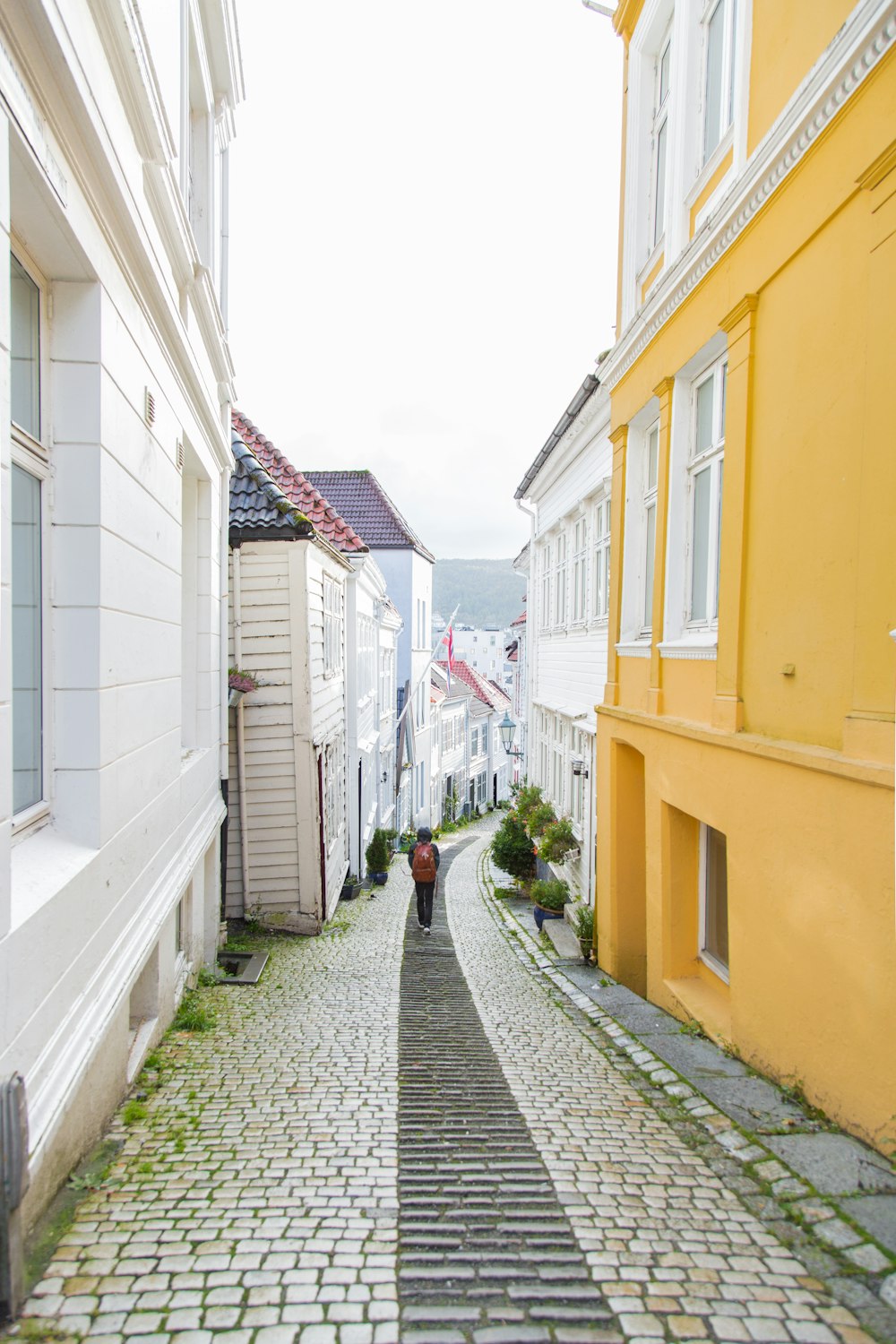 person walking alone at narrow alley