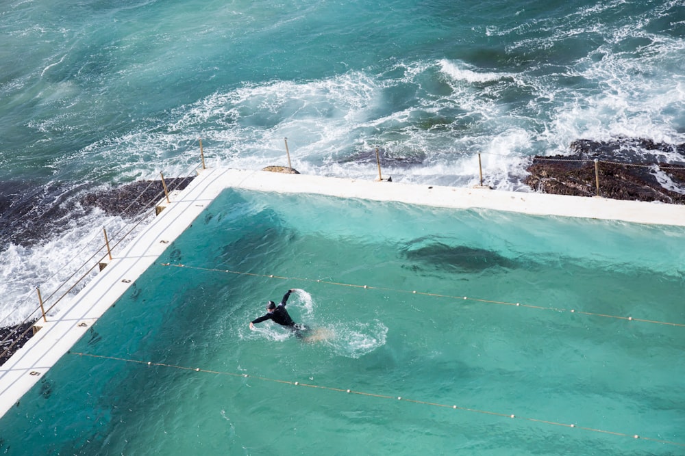 person swimming on pool