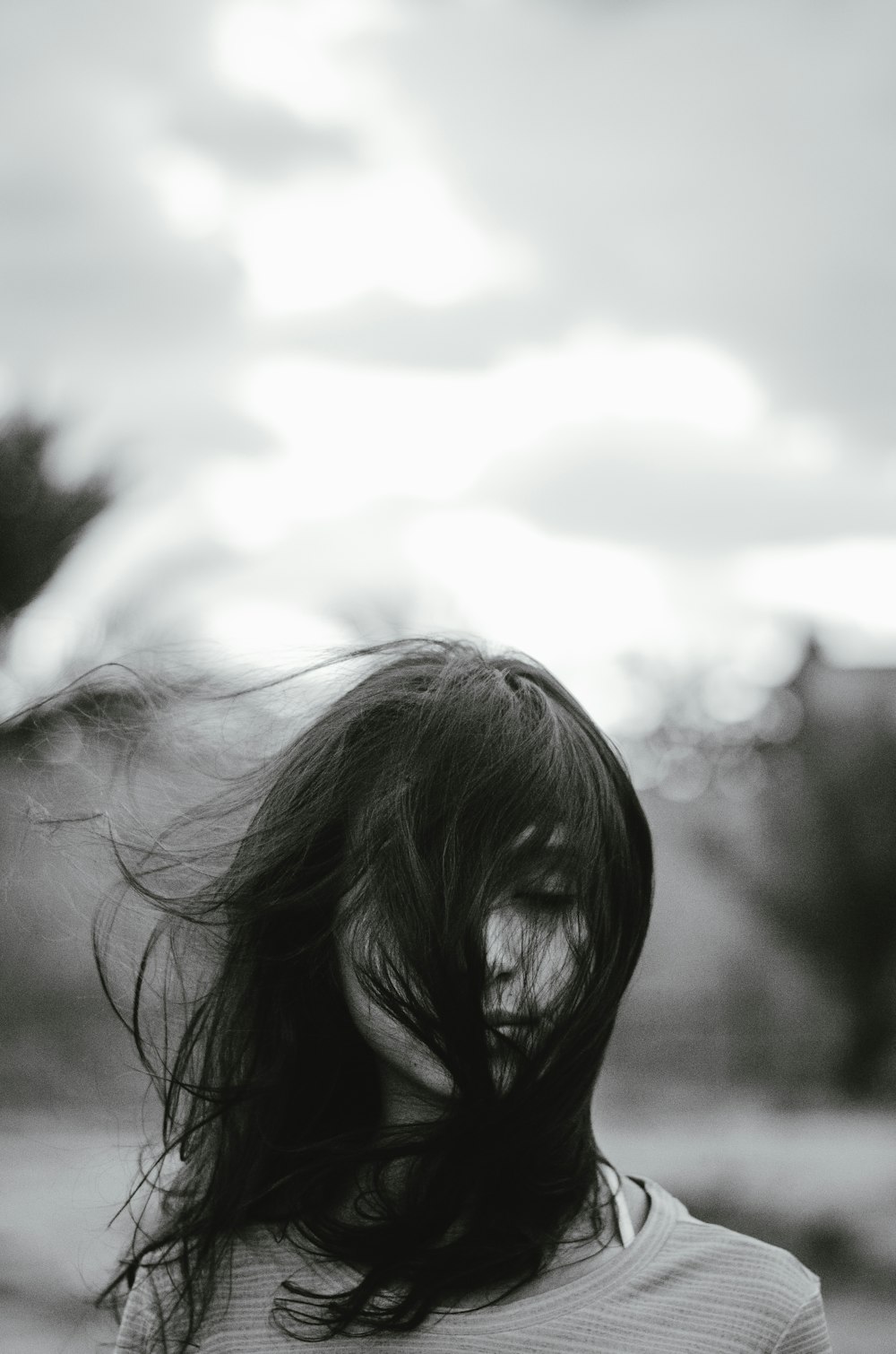 woman with closed eyes standing outdoors