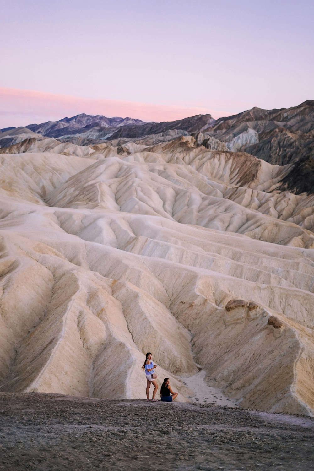 two people standing near sand dunes