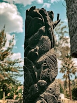 A beautifully crafted wooden sculpture placed in a serene setting.