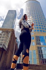 A sleek model posing confidently in front of a city skyline.