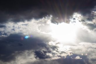 A sunrise breaking through clouds, representing new beginnings.