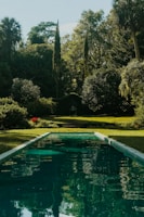A serene garden with a reflection of the Taj Mahal.