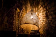 Pastoral woven wall lamp adding texture and warmth to a quiet reading nook.