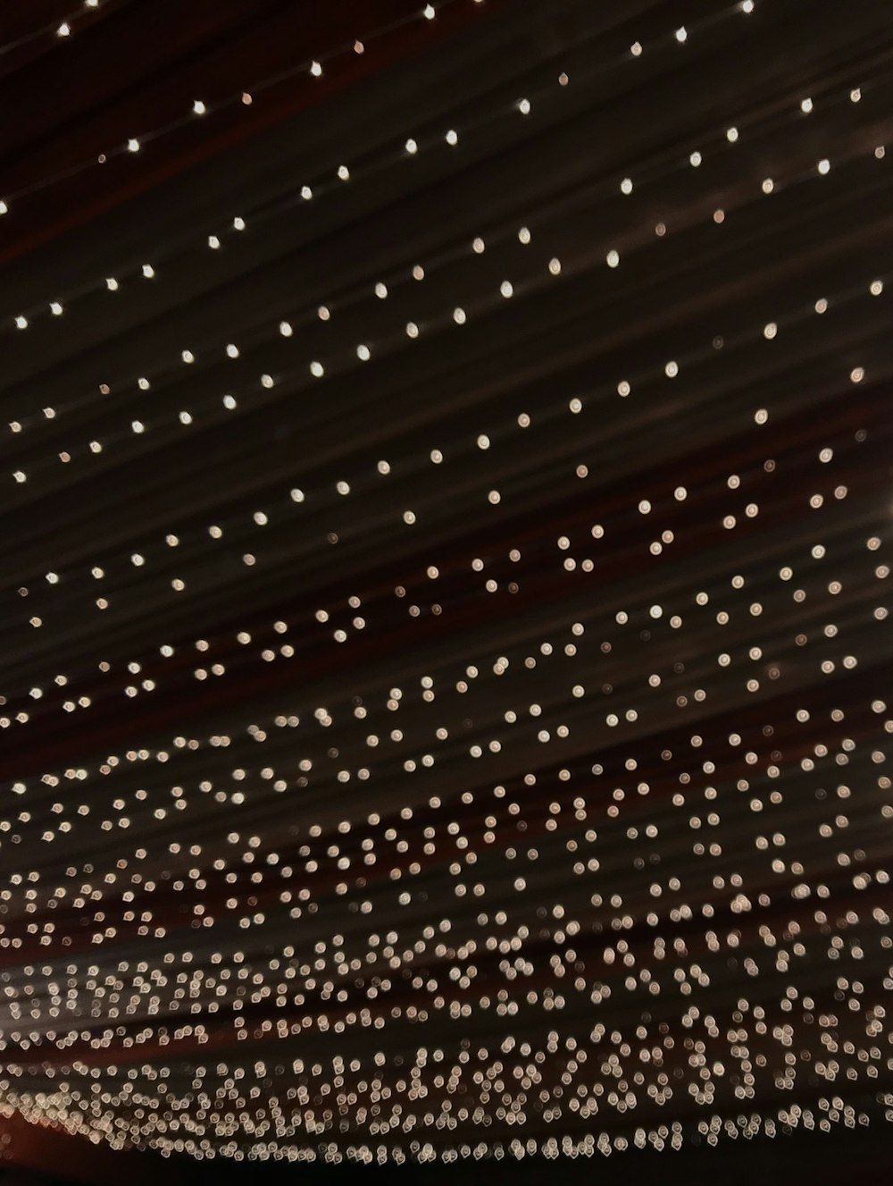the ceiling of a building with lights on it