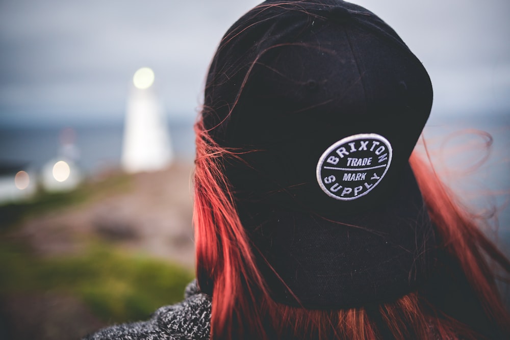 selective focus photography of woman wearing black cap