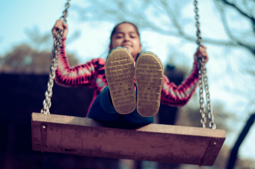 girl riding on the swing